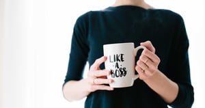 a close up of a woman holding a mug saying