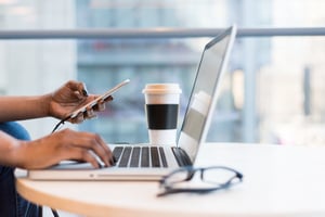 live video for customer service showing a laptop, a mobile phone, a coffe and glasses